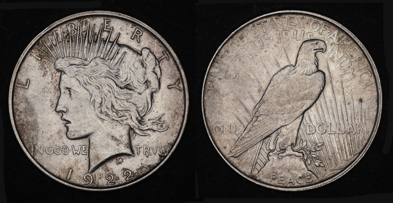1922-D Peace dollar showing Liberty and the date on the obverse, and an eagle with the D mint mark on the reverse