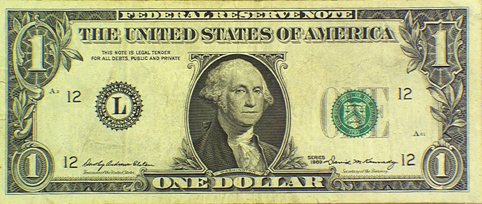 Series 1969 $1 note with both serials absent and green Treasury seal present; PMG determined the serials had been chemically removed.