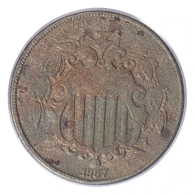 1867 Shield nickel obverse: shield, motto and date; this example has substantial surface problems.