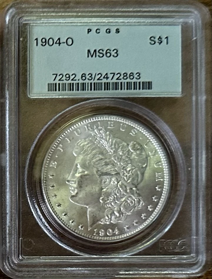 A 1904-O Morgan dollar inside a PCGS MS63 grading holder.